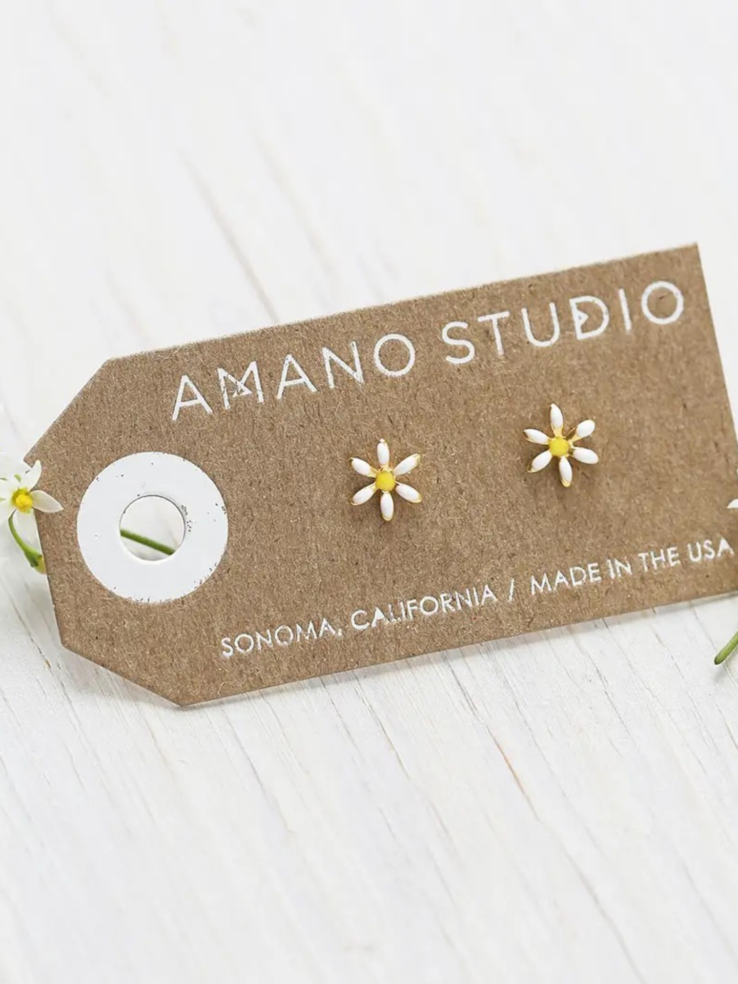 A pair of delicate daisy earrings by Amano Studios featuring floral design and silver hooks, perfect for accessories.