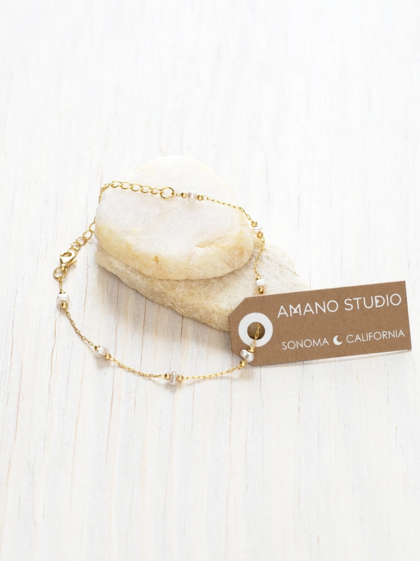 Amano Studios pearl bracelet featuring white pearls on a delicate silver chain, stylish accessory for elegant outfits.