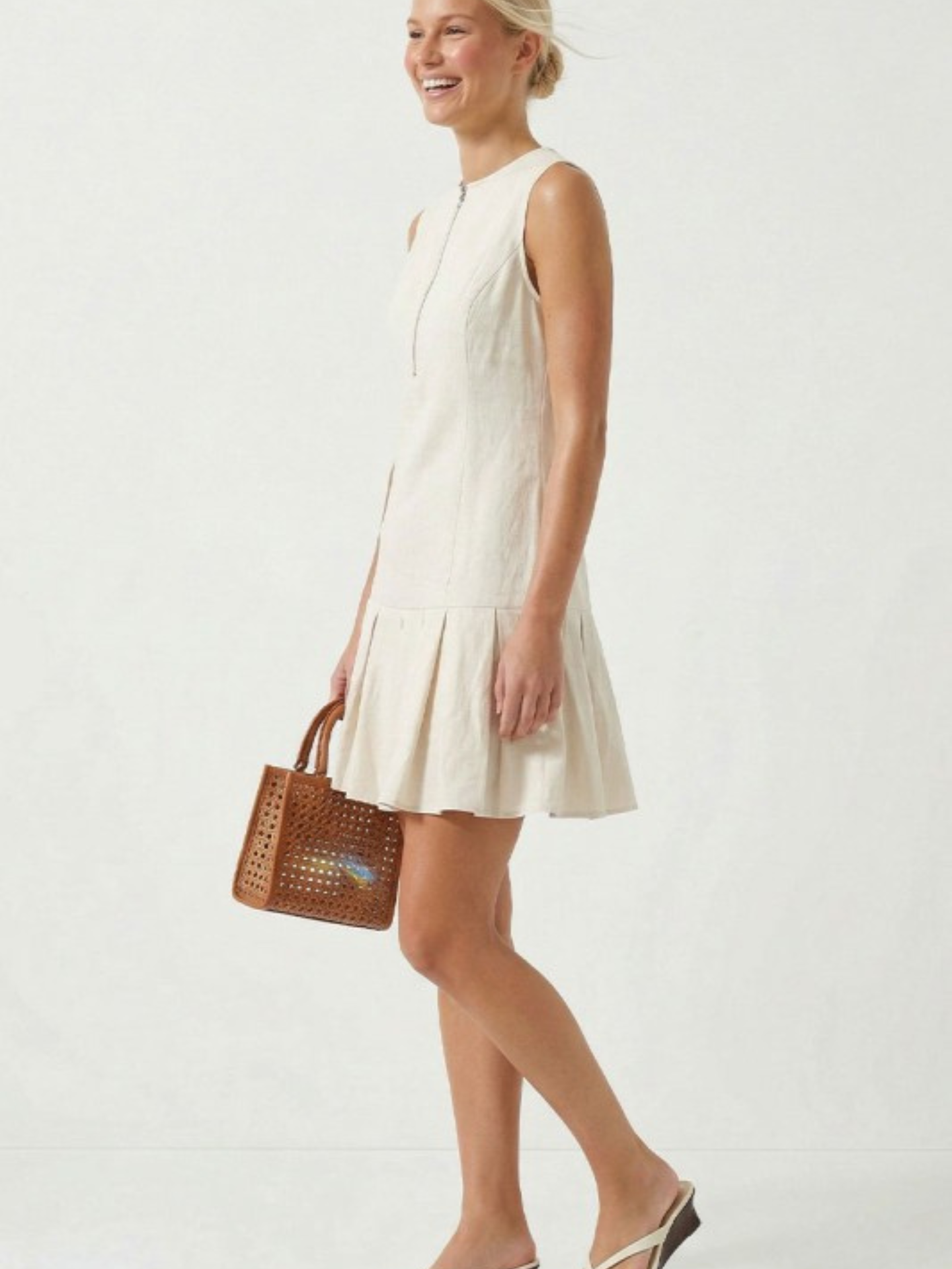 Mimi & Rae Loretta pleated hem mini dress in soft fabric with a flattering fit and stylish pleated hem detail.