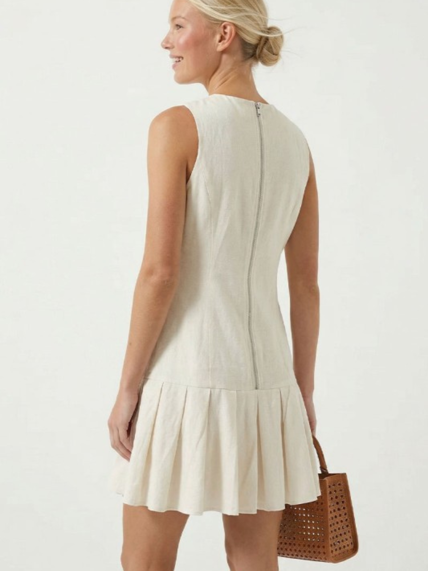 Mimi & Rae Loretta pleated hem mini dress in lightweight fabric, featuring a fitted bodice and flared skirt for a stylish look.