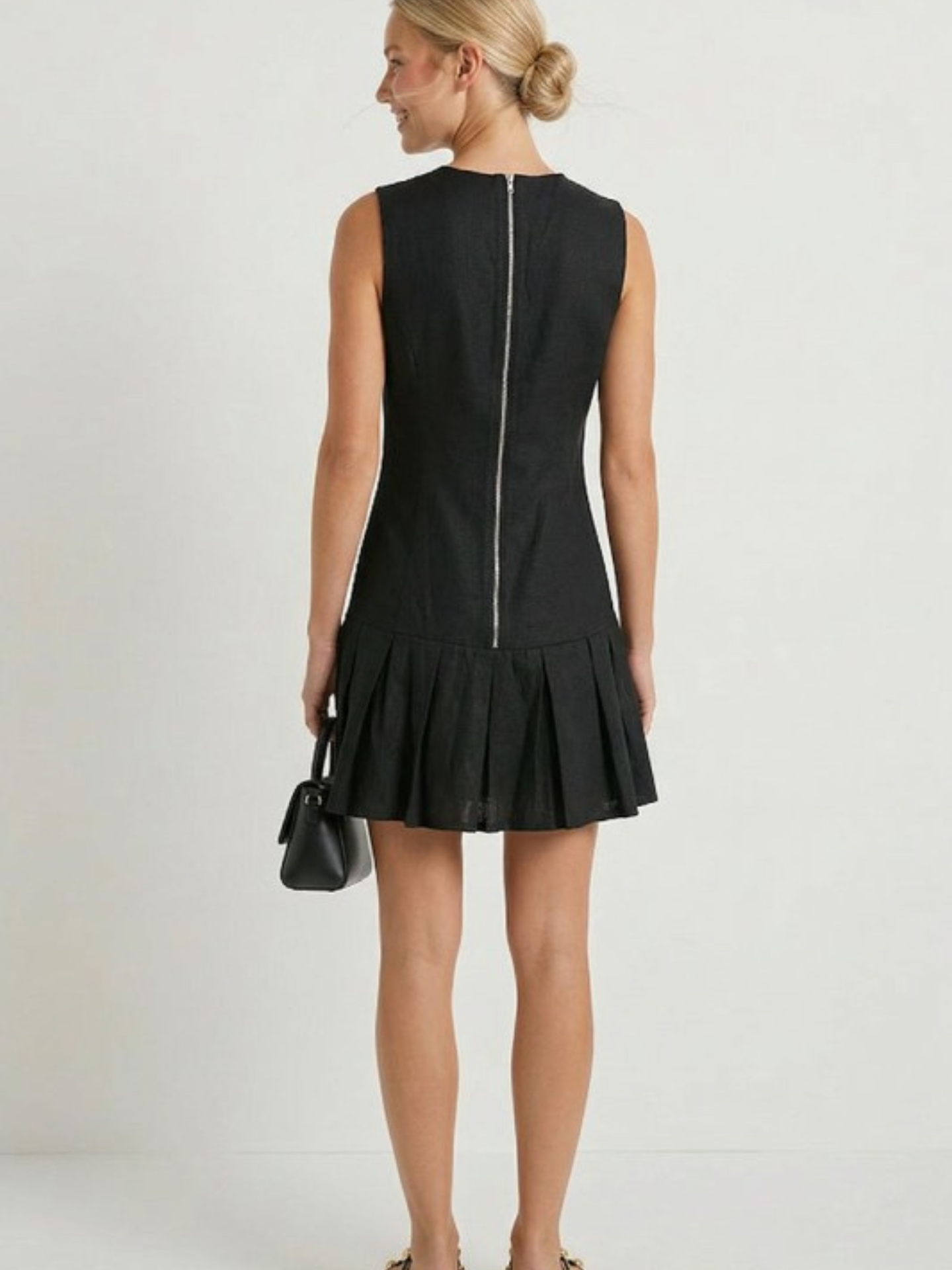 Mimi & Rae Loretta Pleated Hem Mini Dress in a stylish design, featuring a flared hem and elegant fabric for a chic look.