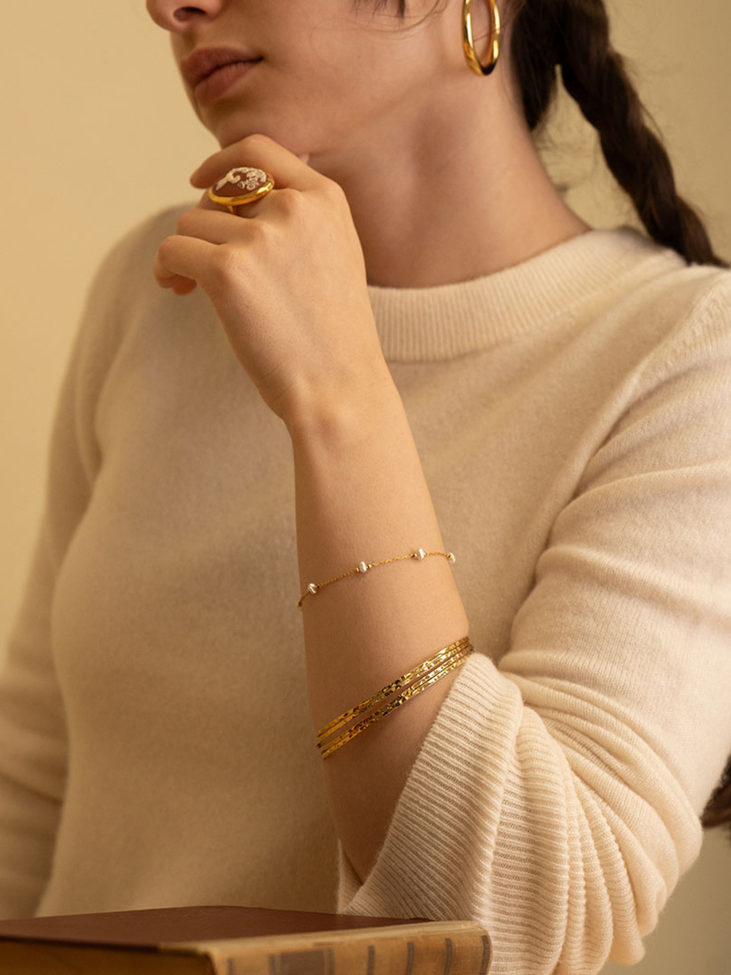Elegant pearl bracelet by Amano Studios featuring a string of lustrous white pearls on a delicate jewelry chain.