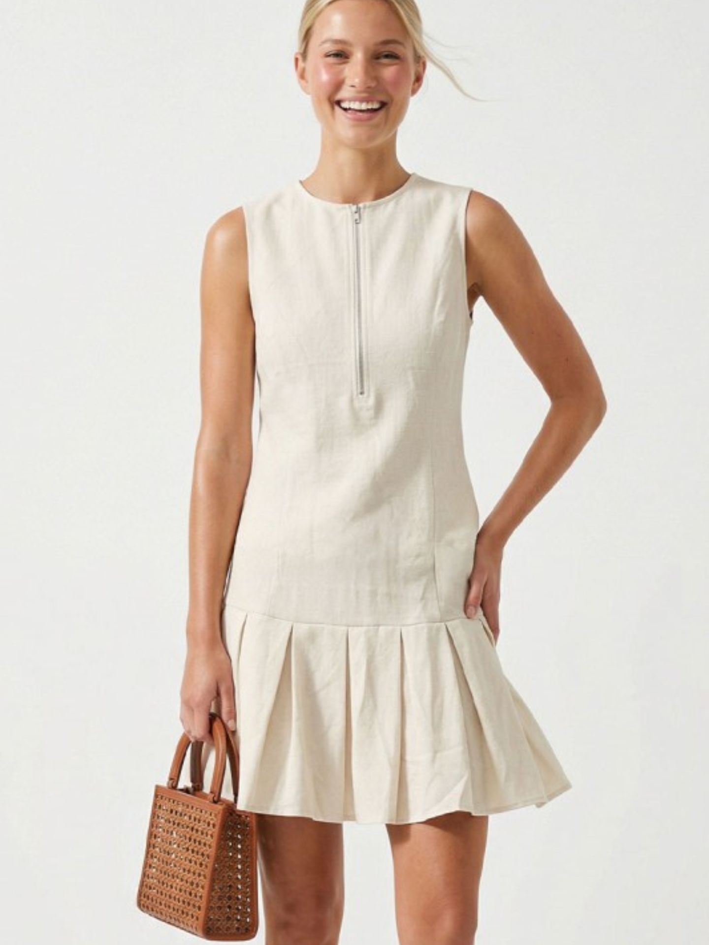 Mimi & Rae Loretta pleated hem mini dress in lightweight fabric with a fitted bodice and flowing skirt, stylish and feminine.