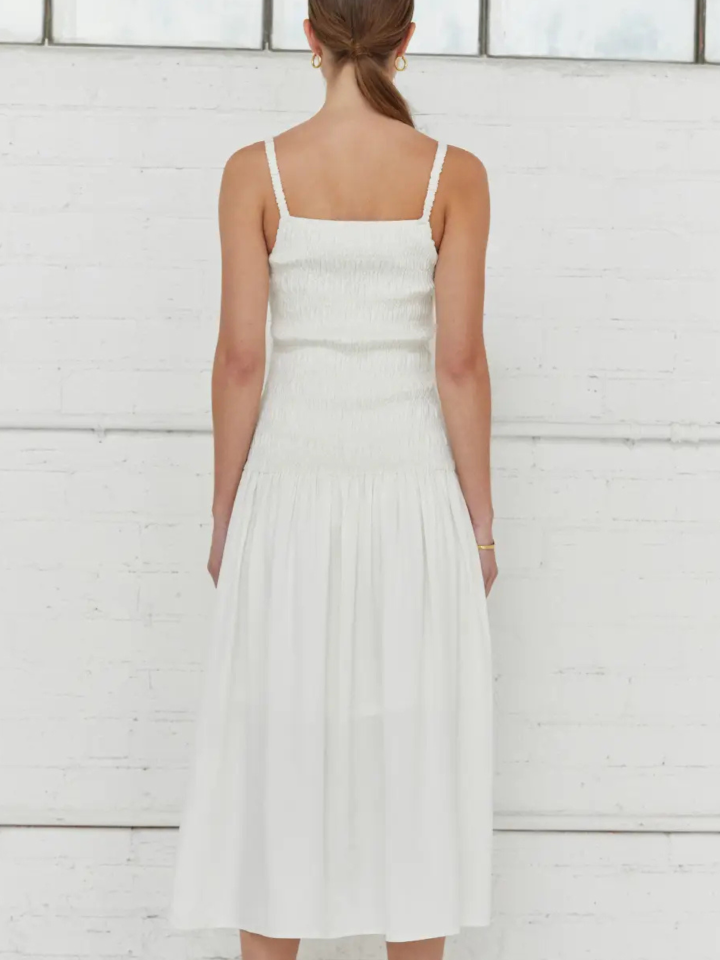 White Crescent smocked body dress, XS size, featuring a fitted bodice and adjustable straps, perfect for casual or summer wear.