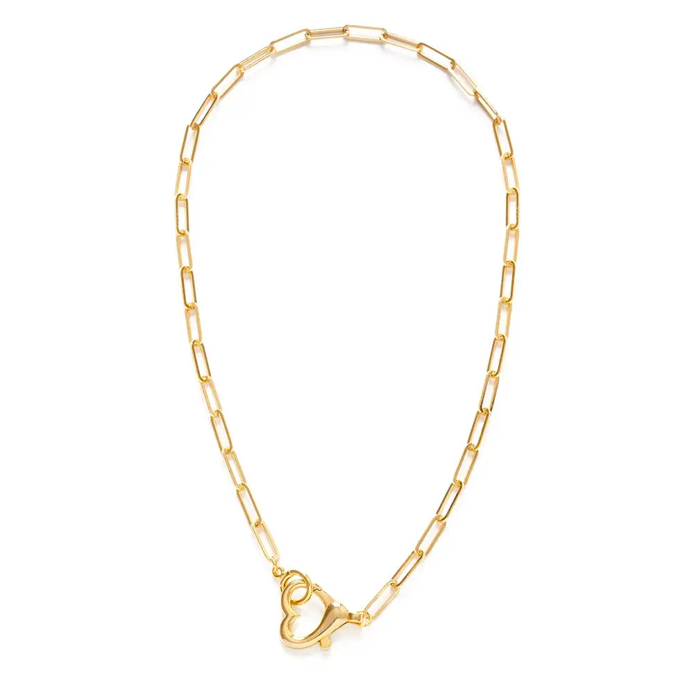 Amano Studios heart necklace with a delicate chain and small heart pendant, shown close-up against a neutral background.