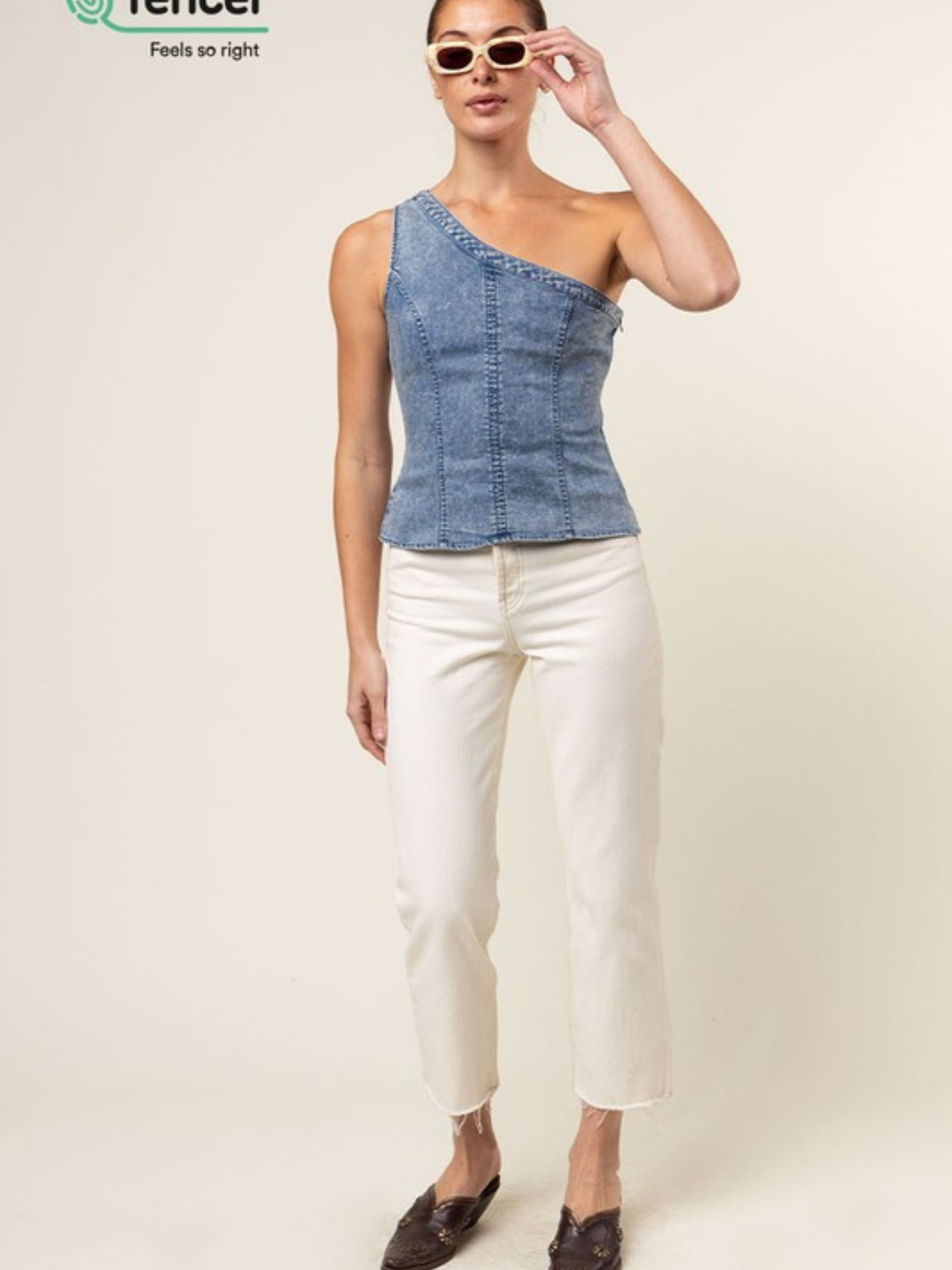 Blue Tencel one-shoulder braided blouse by Mimi & Rae, stylish women's apparel with a relaxed fit and elegant design.