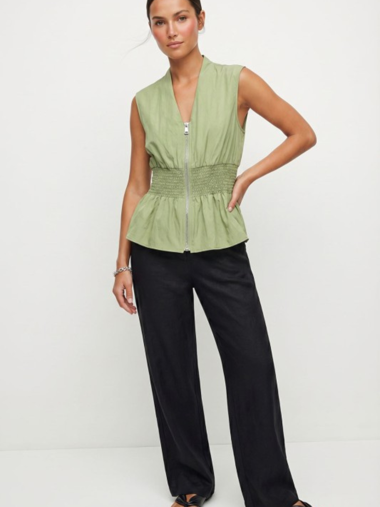 White Ivy Zipped and Smocked Blouse by Mimi & Rae, featuring a fitted design with smocking and a front zipper detail.