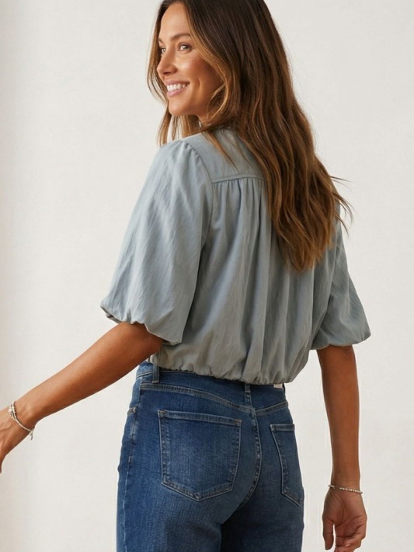 Mimi & Rae Bubble Cropped Button Down shirt in light fabric with a relaxed fit and button front, displayed on a hanger.
