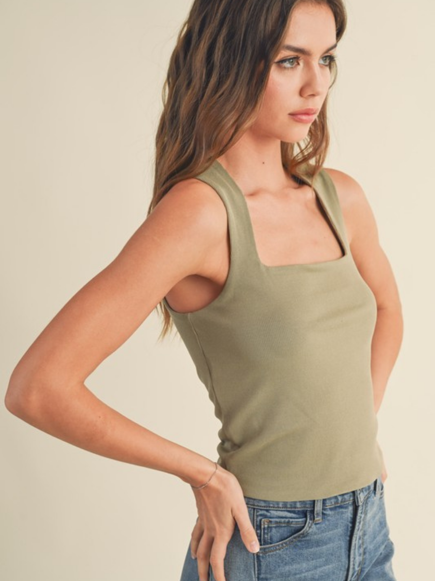 Green textured square neck tank top by Miou Muse, showcasing a close-up of the fabric and stylish square neckline.